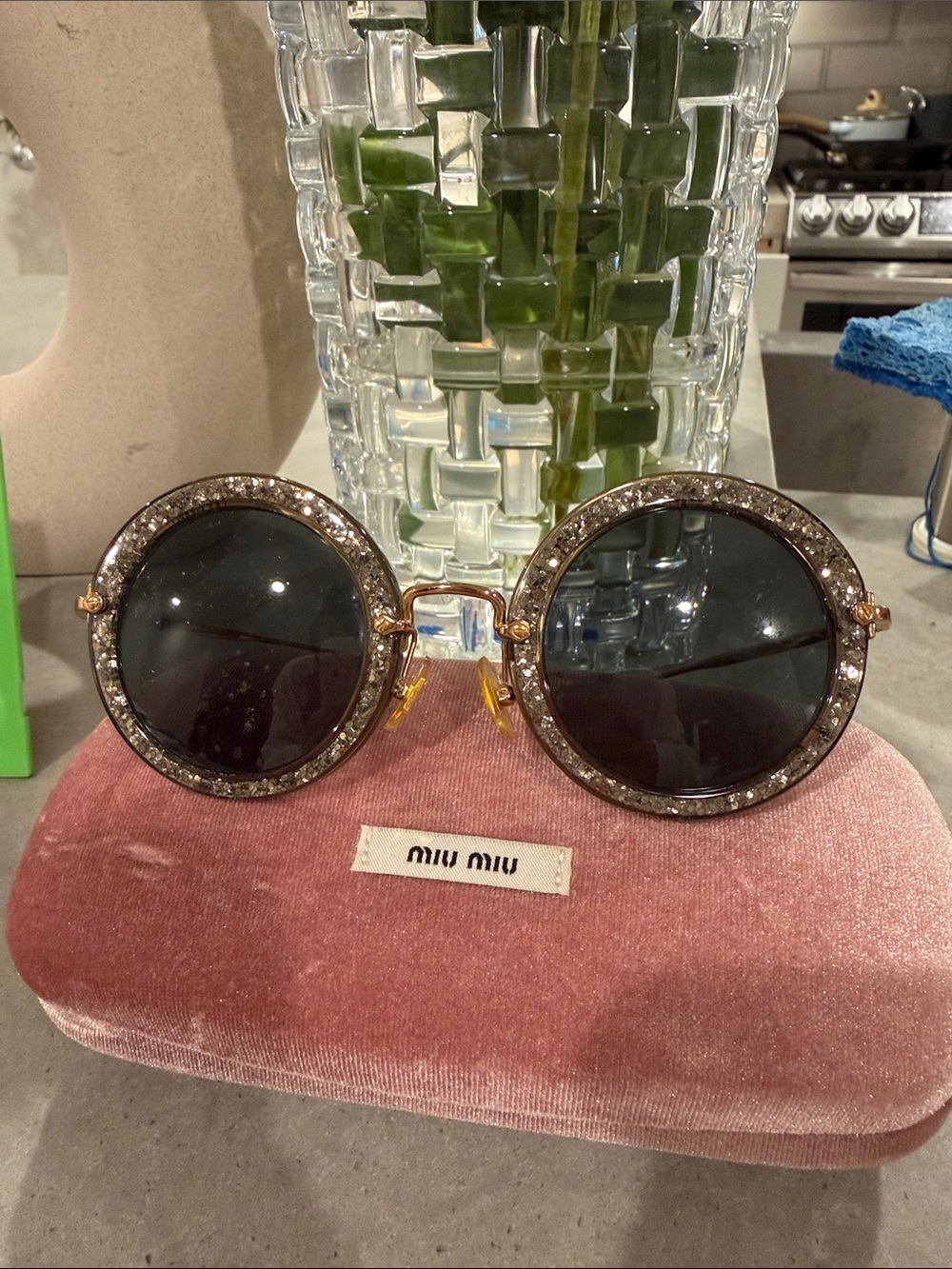 Miu Miu Black Lens Round Sunglasses with Gold-Tone Crystal Rim